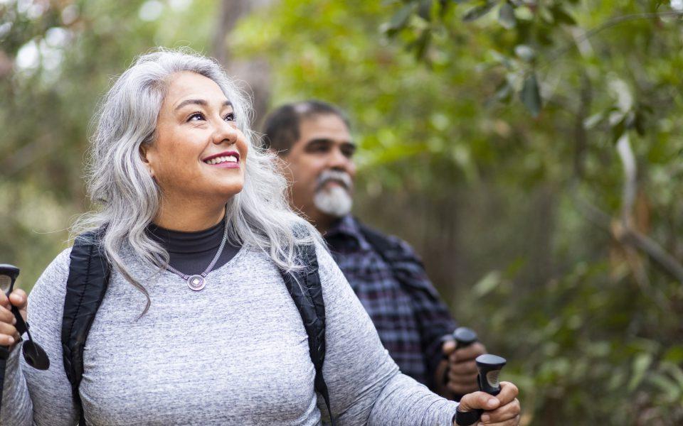 Senior couple hiking in trees