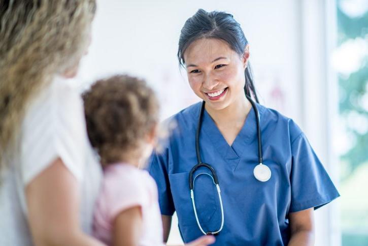 Female doctor with a young girl patient and her mother